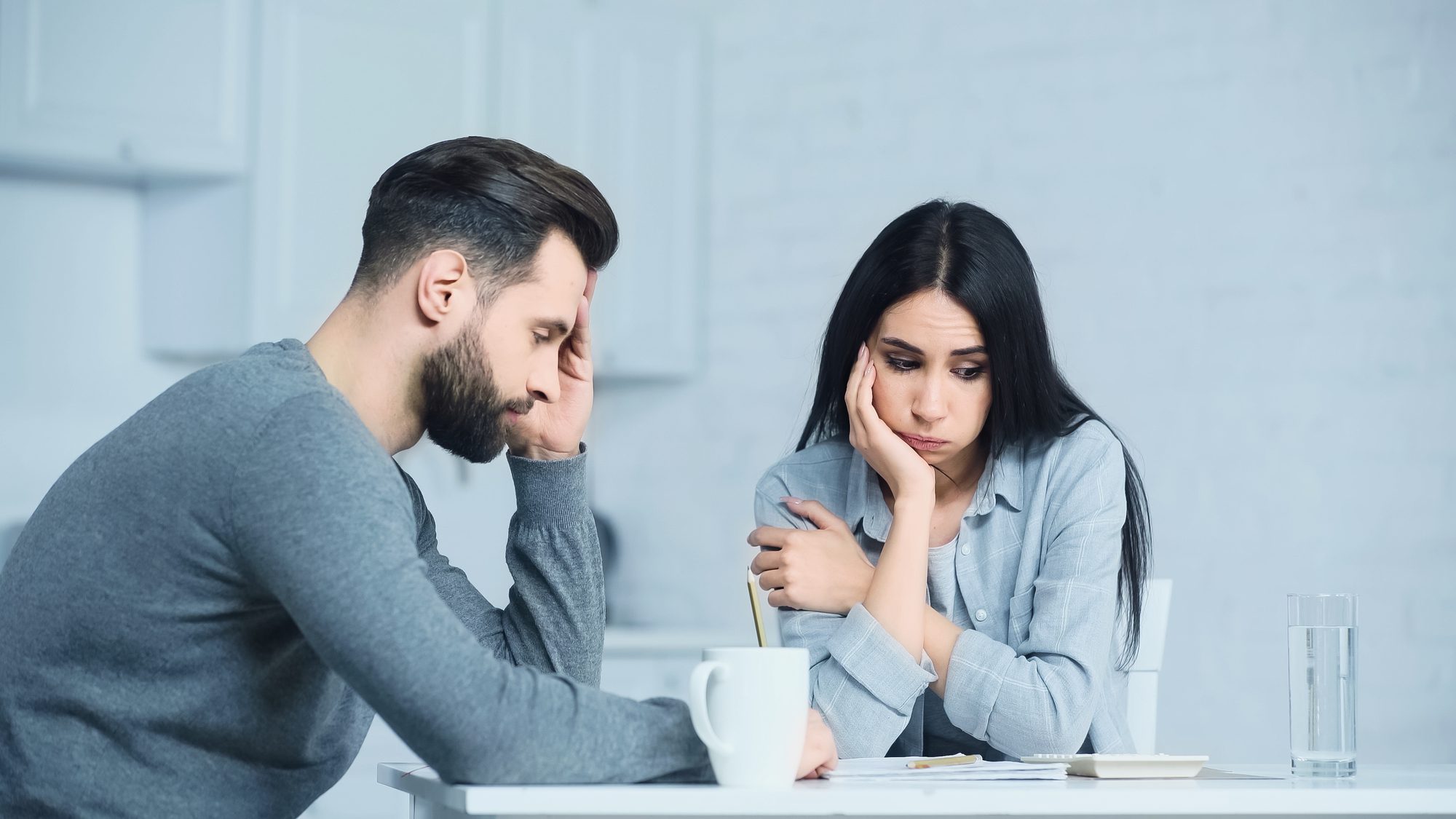worried couple looking at their bills together