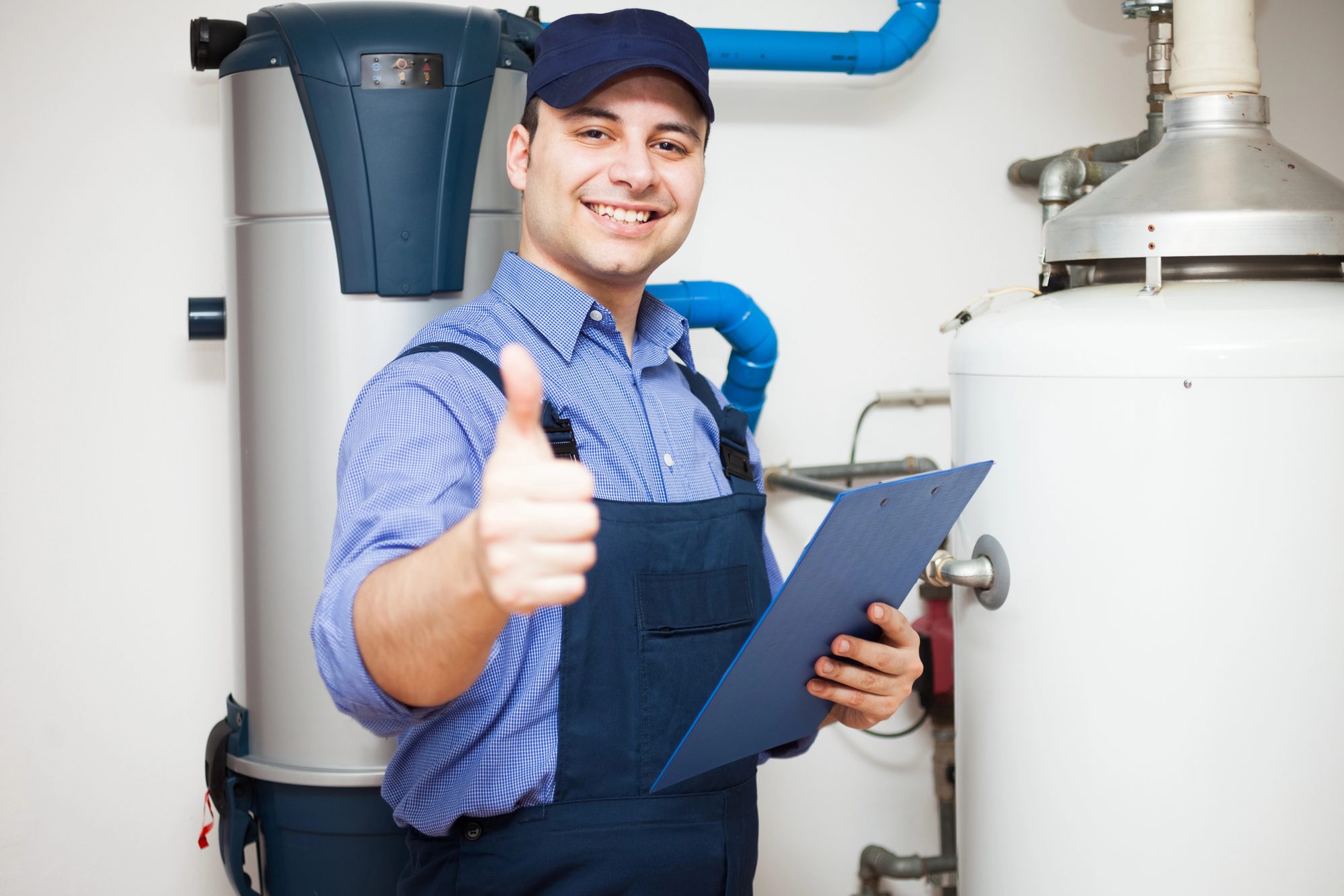 smiling plumber servicing water heater