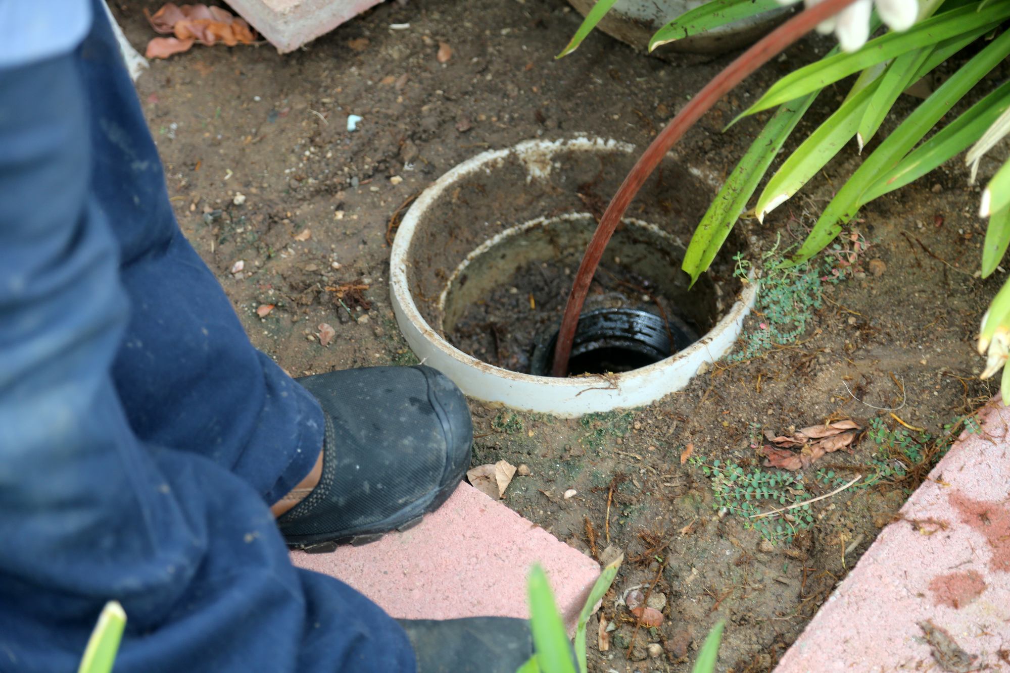 Sewer cleaning. A plumber uses a sewer snake to clean blockage i Sewer Line Repair, Clogged Drain